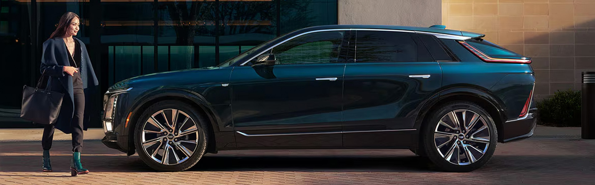 2026 Cadillac LYRIQ luxury electric SUV parked outside a modern office building.